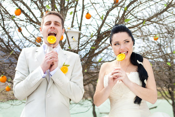 Bride and groom posing in the park. Stylized Wedding in oranges