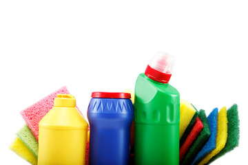 Detergent bottles, rubber gloves and cleaning sponge on a white