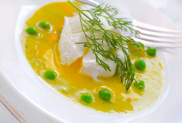 Fresh soup from green peas and egg-poached