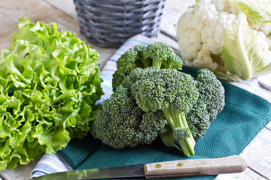 Fresh uncooked cauliflower, broccoli on table