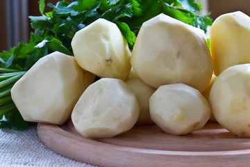 Fresh uncooked potato on wooden board