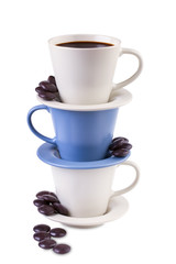 Three  coffee cups stacked together with chocolates