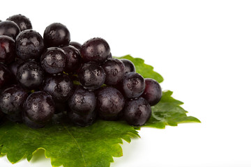 Red grape with green leaf  isolated on white background