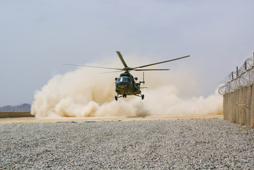 helicopter landing in cloud of dust on desert © mariusz szczygieł