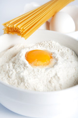 Egg yolk in a bowl of flour