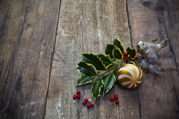 Twig of holly tree lying on old wooden floor