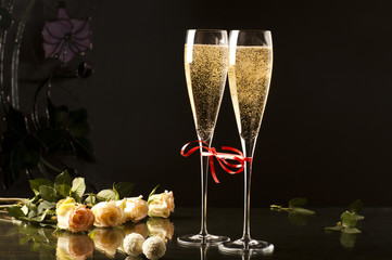two glasses of champagne on dark background