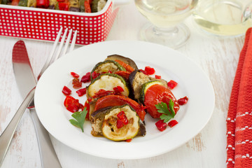 ratatouille on the white plate and glass of white wine