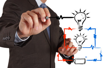businessman hand draws electrical diagram