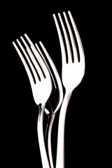 metal forks isolated on black background