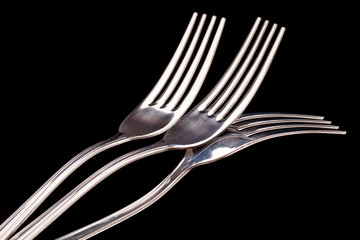 metal forks isolated on black background