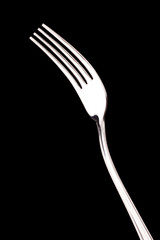 metal fork isolated on black background
