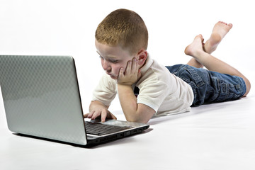 Redheaded little boy with computer