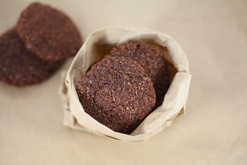 Coconut chocolate cookies in brown paper bag