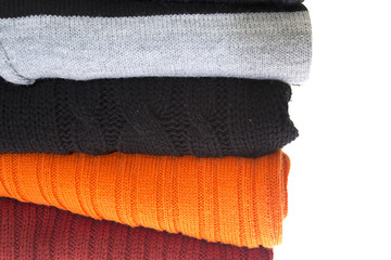 A stack of sweaters isolated on a white
