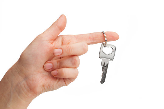 hand holding key isolated on white
