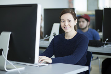 Beautiful student working with a computer in class