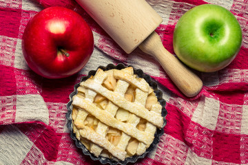 Apple pie with fruits and a rolling pin