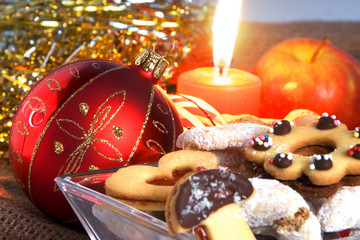 Christmas atmosphere - candle, sweets and Christmas decorations