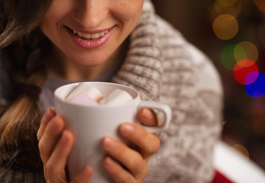 Closeup On Hot Chocolate With Marshmallows In Hand Of Happy Girl