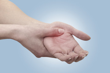 Acute pain in a man palm. Female holding hand to spot of palm-ac