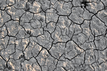 Dry broken ground under sun