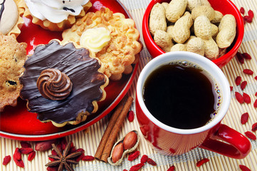Fototapeta na wymiar Cup of coffee, cakes and peanuts