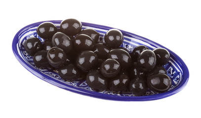 Olives black watered with olive oil in a bowl isolated on a whit