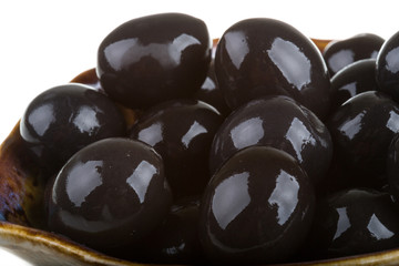 Olives black watered with olive oil in a bowl isolated on a whit
