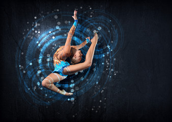 Young woman in gymnast suit posing