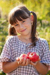 Cute little girl with apple in hand