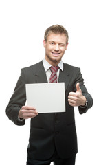 cheerful winking businessman holding sign