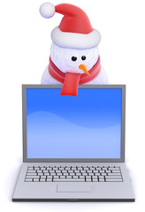 Snowman in Santa hat behind laptop