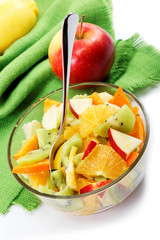 Fresh fruits salad on a green canvas.