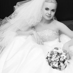 portrait of a beautiful blonde bride with great vapory veil and