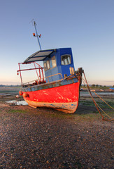 Fototapeta na wymiar Fishing boat in the sand
