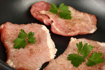 fry pork in a frying pan close-up