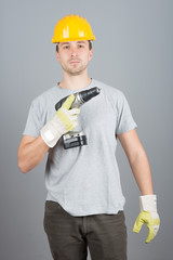 Young male construction worker with screwdriver
