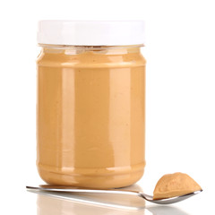 Delicious peanut butter in jar isolated on white