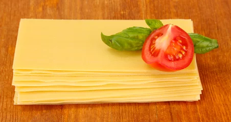 Foto op Plexiglas Uncooked lasagna pasta on wooden background © Africa Studio