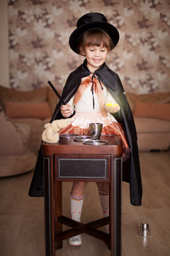 child posing in Attire conjurer with a magic wand