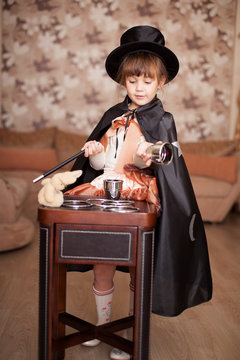 child posing in Attire conjurer with a magic wand
