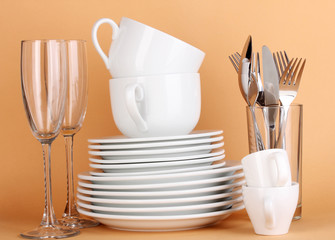 Clean white dishes on beige background