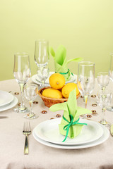 Table setting in green and yellow tones on color  background