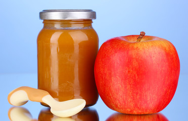 Useful and tasty baby food with apple and spoon
