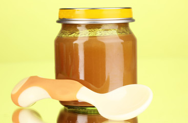 Useful and tasty baby food with beige small spoon