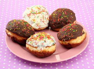 Tasty donuts on color plate on color background