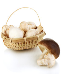 Fresh mushrooms in basket isolated on white