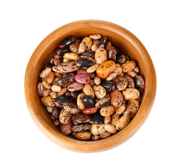 Beans in wooden bowl isolated on white