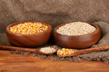 Raw corn and wheat in wooden bowls
